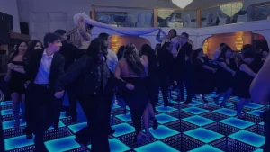 People dancing on a festive LED dance floor during a holiday party