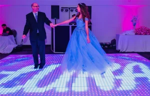 Guests dancing and taking photos on a Pixel LED Dance Floor during the wedding reception