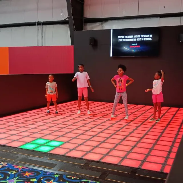 Colorful interactive floor games designed for kids, featuring cartoon visuals and motion-sensing gameplay on an interactive game floor.