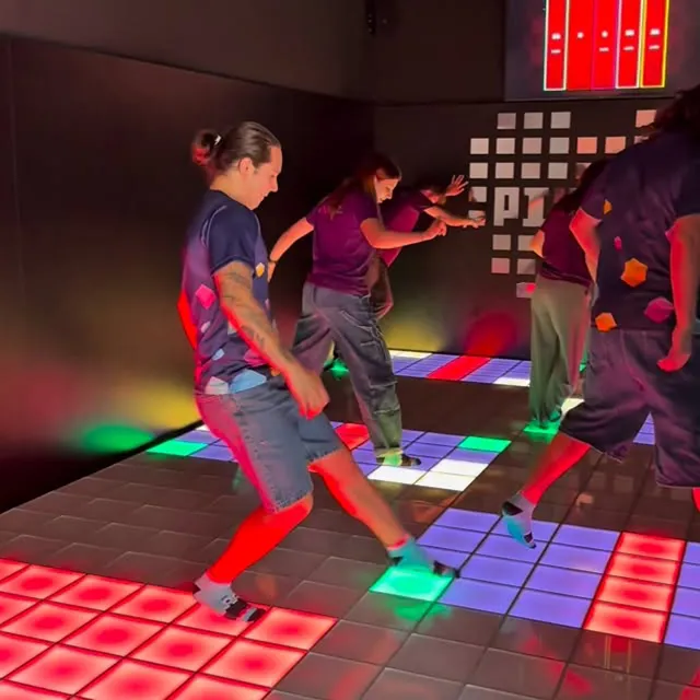 Players enjoying team collaboration and competitive challenges on the Interactive Game Floor.