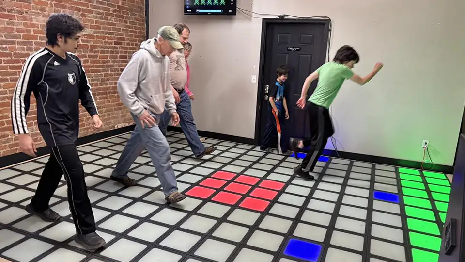 Activate Games style interactive LED game floor with players jumping on light tiles