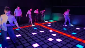 people recording videos of interactive LED game floor for TikTok and social media sharing
