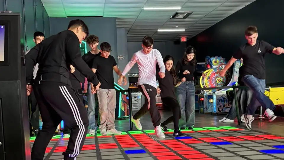 group of players playing interactive game floor with LED tiles in competitive mode