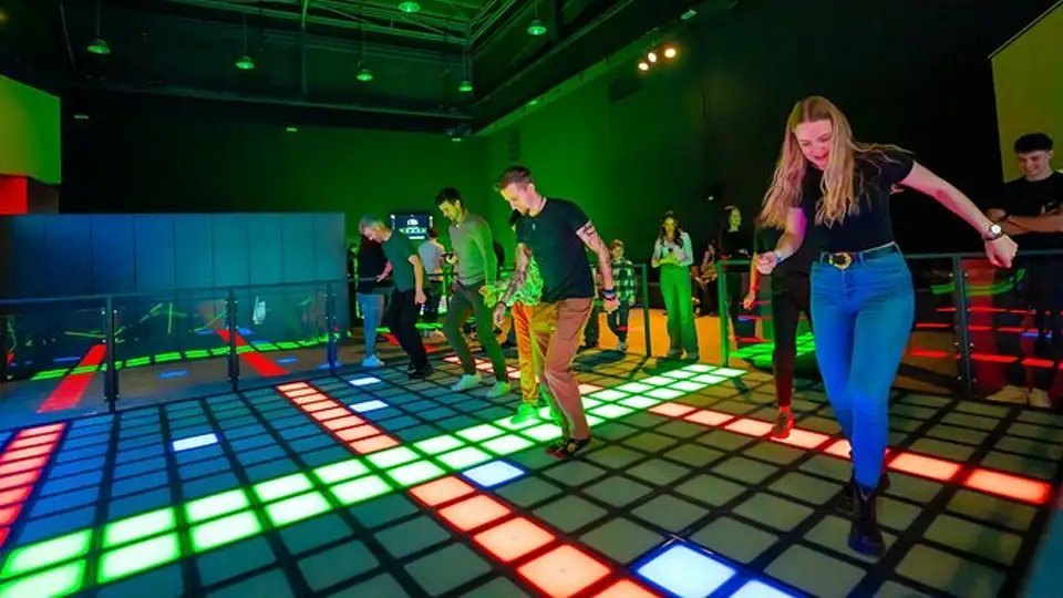 Players enjoying an immersive interactive game floor experience similar to Activate Games floor in a commercial entertainment center.