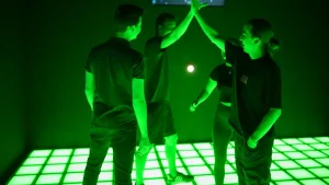 players inside an activate style game room reacting to LED floor and wall targets