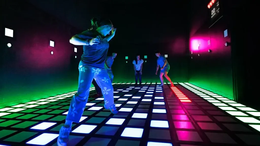 active gaming business model showing group players in an indoor entertainment venue