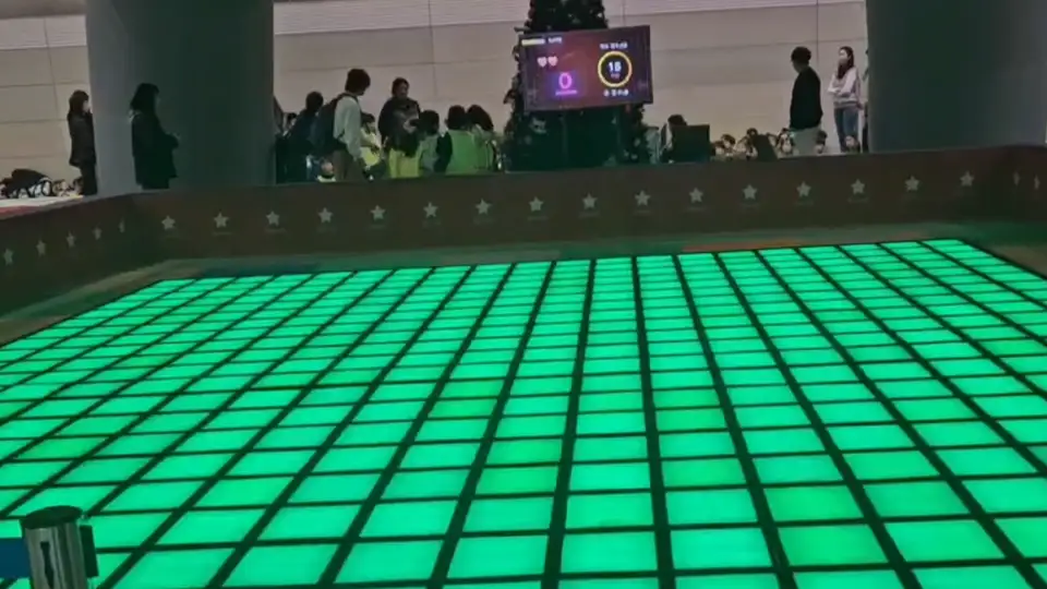 A wide view of a commercial LED grid game floor installation, highlighting its modular design and flexible gameplay for venue operators.