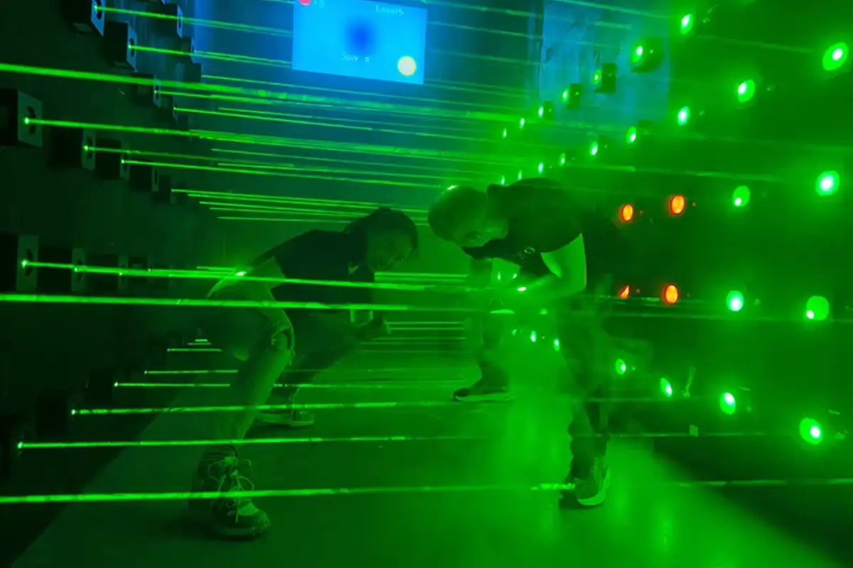 Commercial interactive laser maze challenge system built with precision sensors, offering a high-throughput attraction for entertainment venues