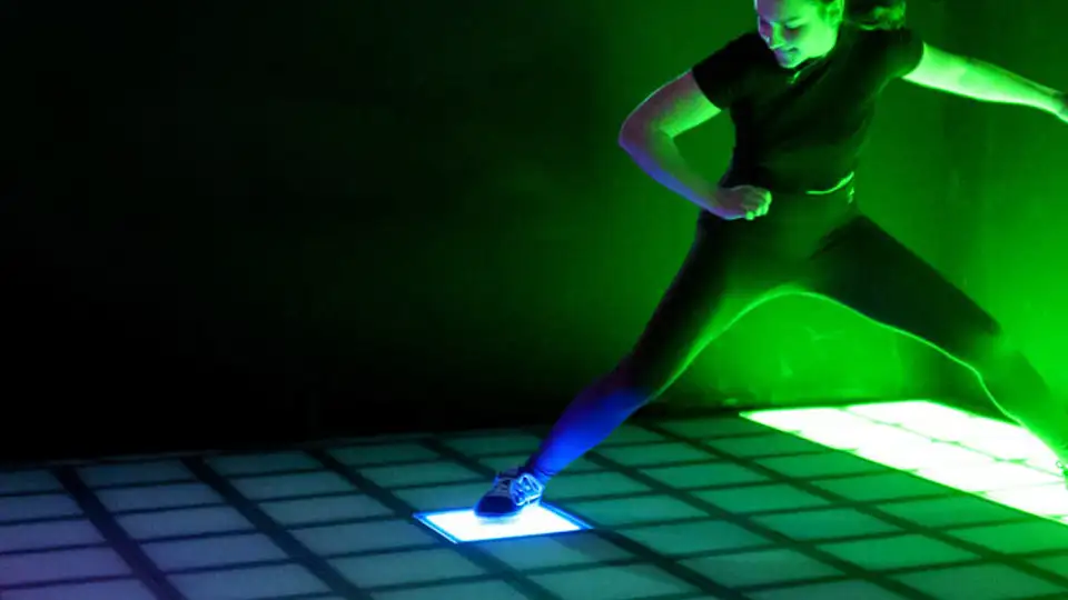 Close-up of high-durability modular LED game tiles featuring tempered glass and integrated motion sensors.