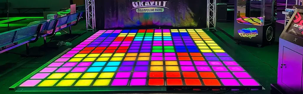 activate games cost comparison showing interactive gaming room with LED floor and multiplayer gameplay