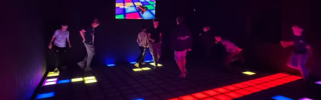 activate games vs vr comparison showing active gaming LED floor room and virtual reality headset gameplay in FEC venue