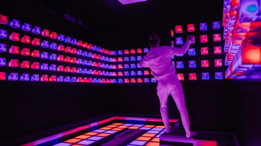 Best Interactive Attractions for FEC Venues (2026 Guide) 4 Commercial push button game wall with illuminated LED buttons showing one of the key FEC attractions in an active gaming room mix