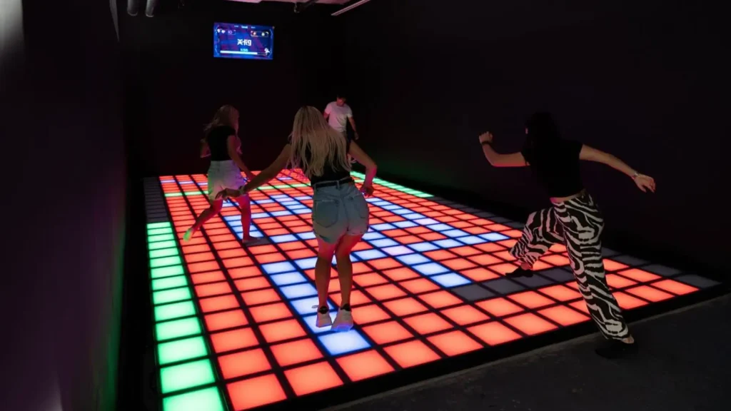 Best Interactive Attractions for FEC Venues (2026 Guide) 1 interactive attractions for FEC venues showing active gaming room with LED game floor and challenge rooms