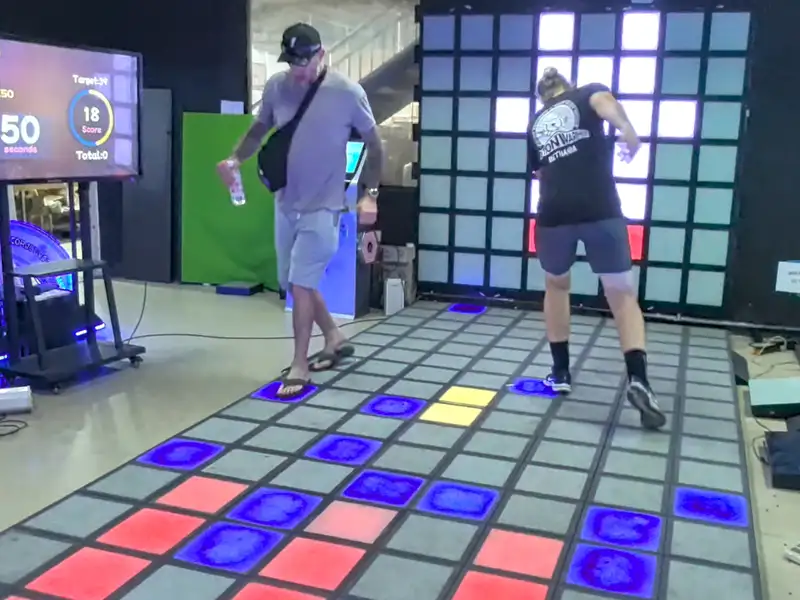 Global visitors testing interactive game floor system