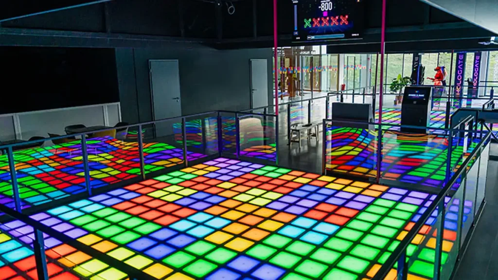 interactive game floor attraction for FEC venue with players reacting to LED tiles