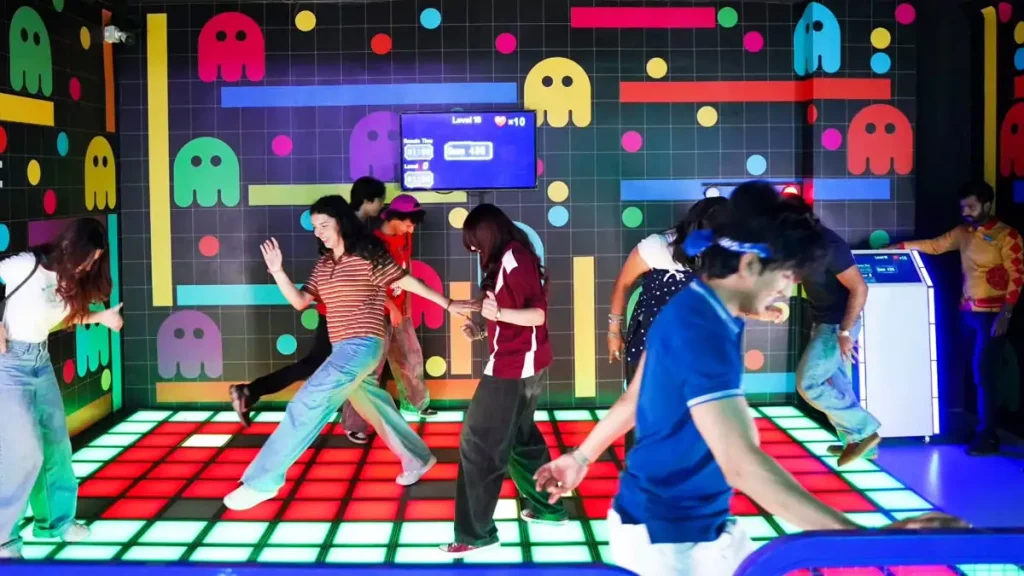 players competing inside multiplayer LED floor game attraction