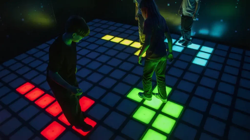 Active Gaming Room ROI: How FEC Operators Maximize Returns (2026) 2 Multiple player groups rotating through active gaming room challenge rooms during peak hours showing throughput and ROI impact