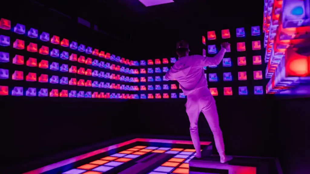 Interactive Gaming Room Games: Pixel Floor, Laser Maze & FEC Guide 5 Interactive climbing wall attraction inside active game room for FEC operators