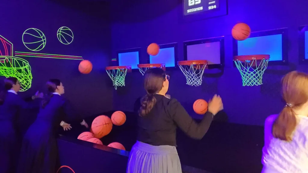 Interactive Hoops Game: Why Basketball Challenge Rooms Work in Active Gaming Venues (2026) 4 Corporate group competing during an interactive hoops game team-building session in a commercial active gaming room