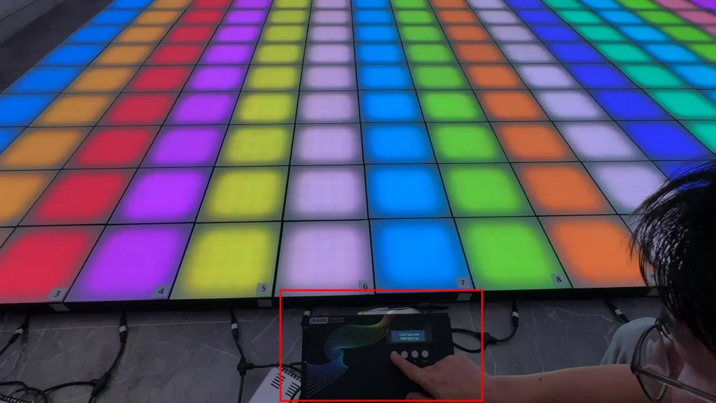 Diagram showing interactive floor tiles, sensors, controller and game software