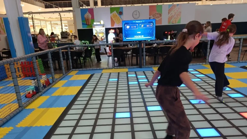 Interactive Games Supplier Checklist: 13 Things to Verify 3 Visitors playing on a commercial interactive game floor while a venue operator monitors the system