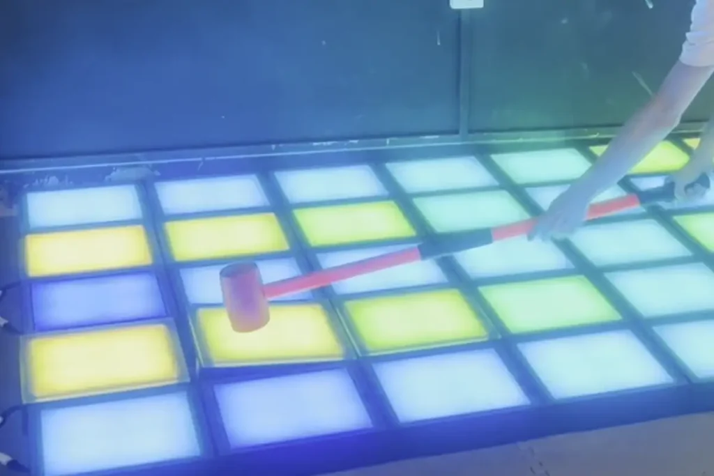 How Interactive Game Floors Work: LED Tiles, Sensors & the Controller 2 Close-up of a walkable RGB LED game floor tile with a 10 mm tempered glass top surface